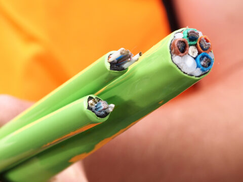 closeup of Installer holding green Nylon jacketed fiber optic Fiber Optic in Colorado Springs, Denver, Fort Collins, Arvada, Boulder, Cheyenne and Surrounding Areas